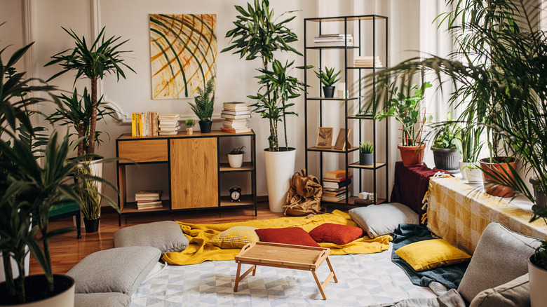 Vintage living room with lots of houseplants.