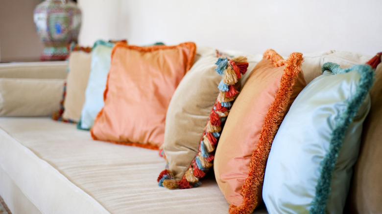 Throw pillows with vibrant colored fringe.