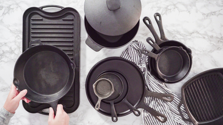 A variety of cast iron cookware on a countertop