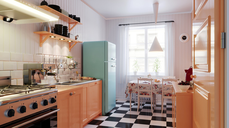 Retro kitchen design with blue fridge and checkered floors
