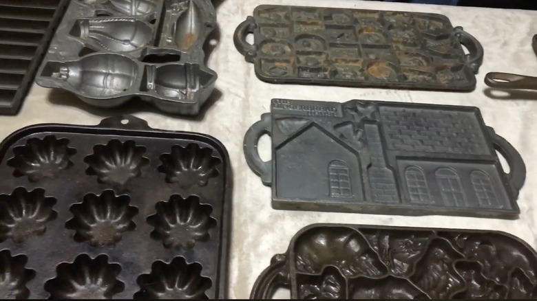 A collection of vintage gem pans spread on a table.