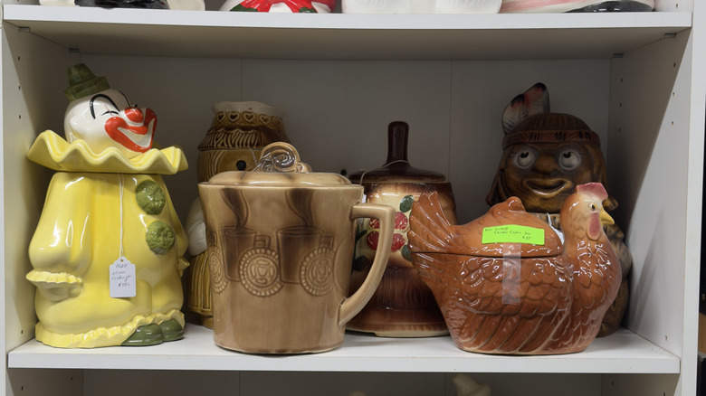 Shelf filled with ceramic cookie jars and storage jars