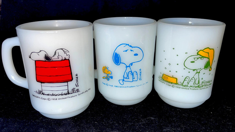 Three Fire-King Snoopy mugs side by side