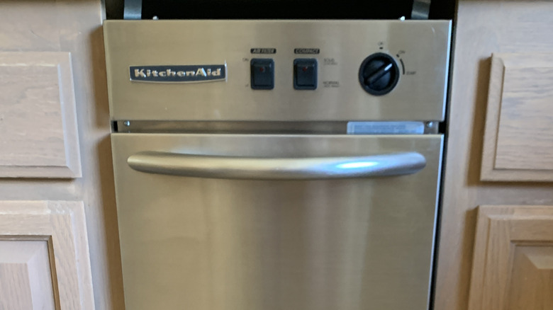 Closeup of trash compactor in a kitchen