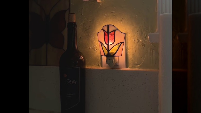 A stained glass night light illuminating a kitchen countertop