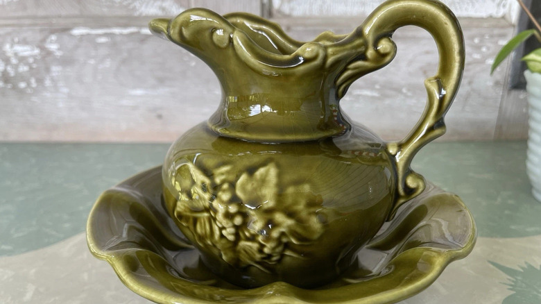 a vintage pitcher and basin set with a floral design from McCoy Pottery