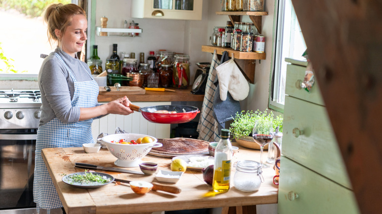 a woman cooking in a rustic kitchen