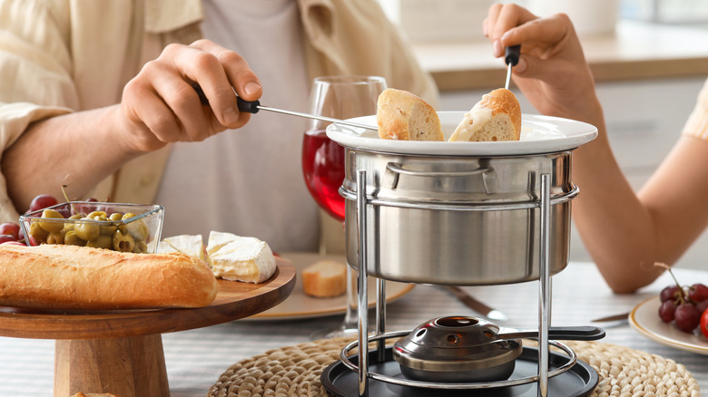 Couple enjoying a cheese fondue