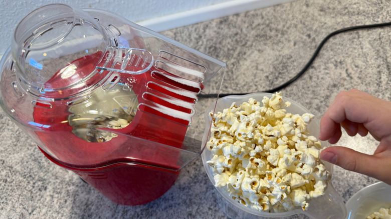 an air popped popcorn maker making popcorn on a countertop