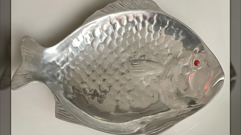 A vintage Arthur Court fish platter with a red stone eye
