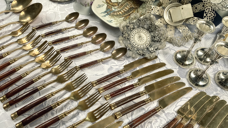 Tarnished silver cutlery on display at a thrift store