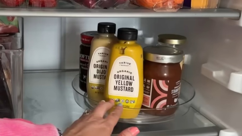 clear turntable with condiments in fridge