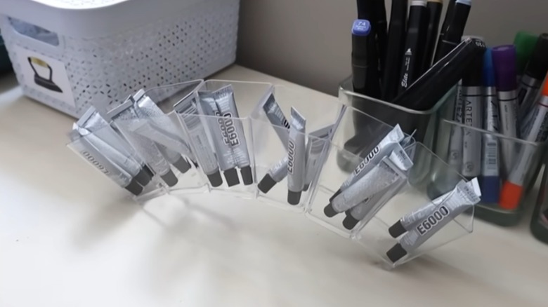 clear plastic containers holding glue tubes