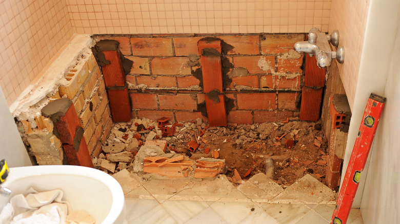 A bathroom with the bathtub removed