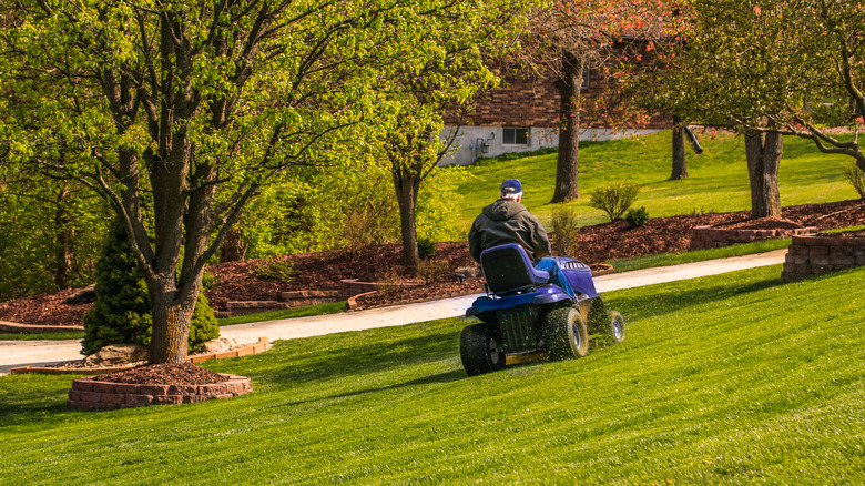 Person on riding lawn mower