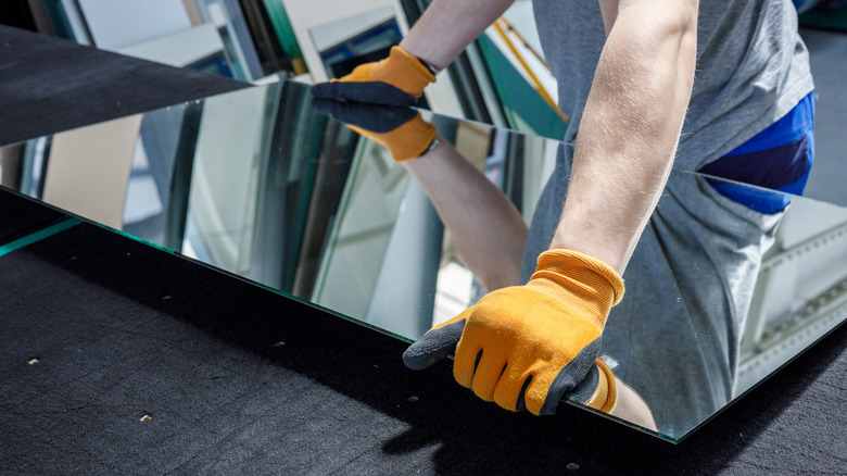 Man installing a mirror
