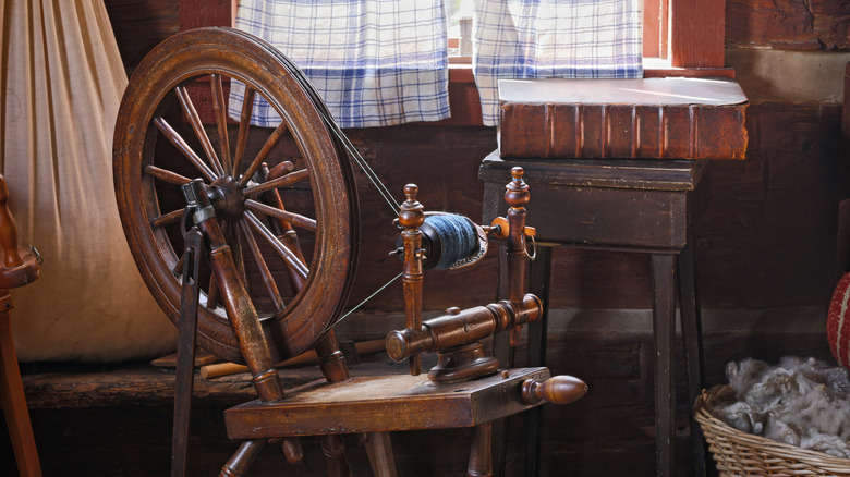 wooden spinning wheel and thread