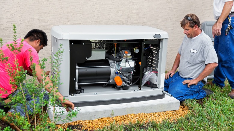 Three men installing permanent generator