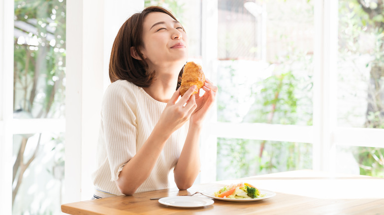 woman enjoying breakfast at home