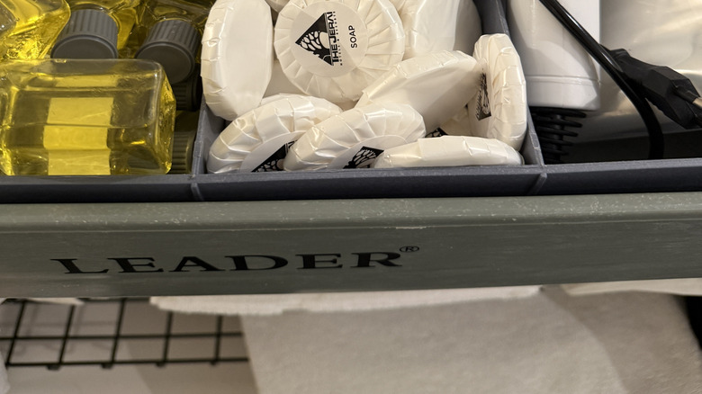 Containers full of smaller-sized hotel toiletries
