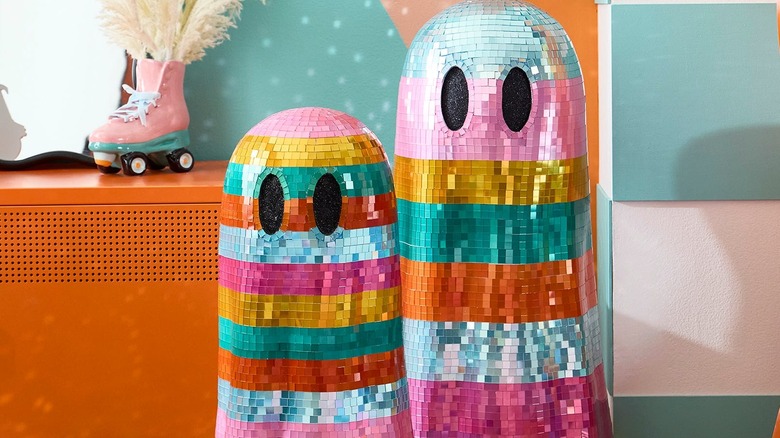 Disco, rainbow colored ghosts standing next to each other against a colorful background