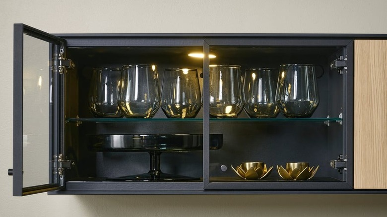 A BOASTAD wall shelf filled with wine glasses and decorative elements