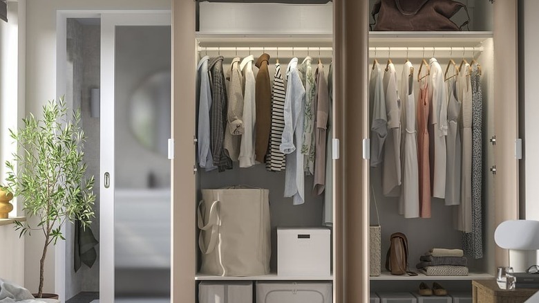PAX / FARDAL wardrobe combination with all doors open, displaying clothes and storage boxes