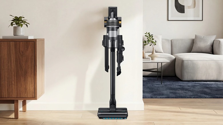 The Samsung Jet 95S Stick Vac in black docked in a hallway