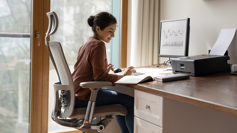 person in chair at desk