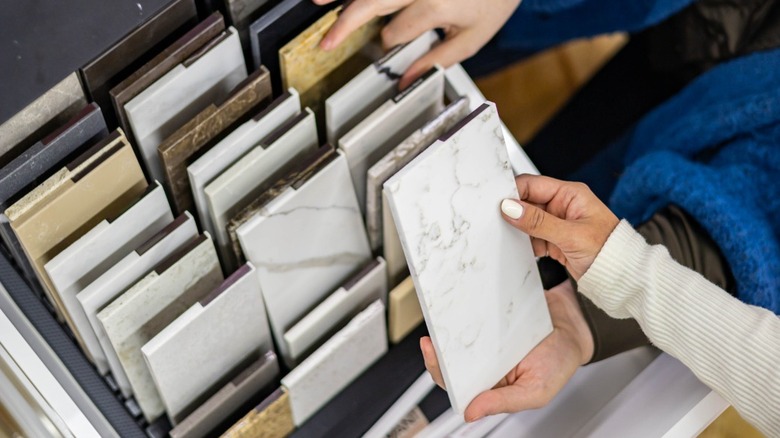 hands selecting countertop samples