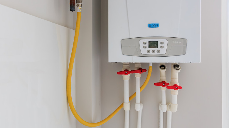 A modern tankless water heater is installed on a wall