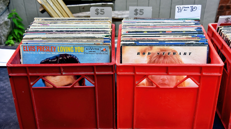 Two red containers filled with albums