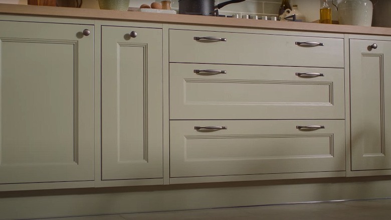 green cabinets with chrome hardware