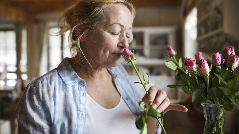 woman smelling roses
