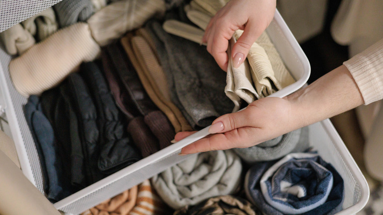 Close-up of a woman organizing a dresser drawer