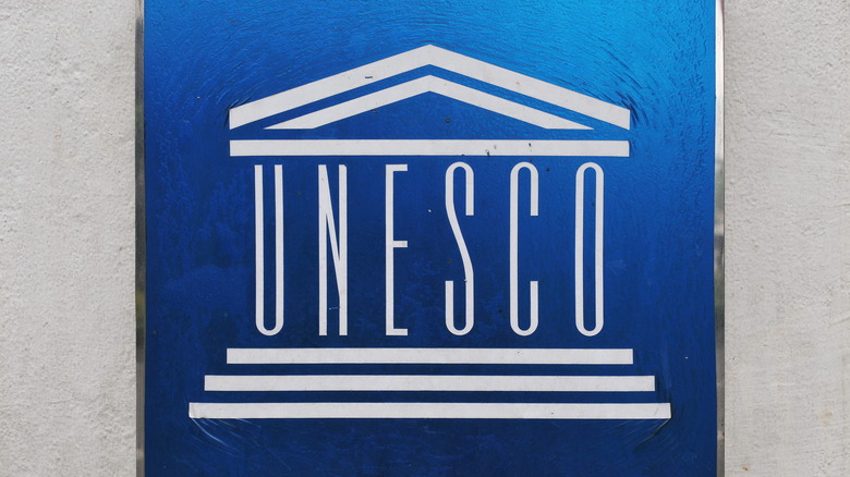 blue UNESCO sign on wall