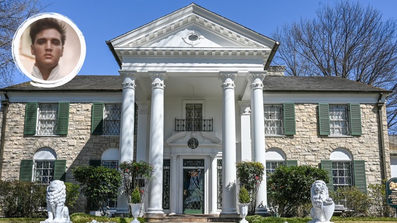 Elvis standing in front of Graceland 