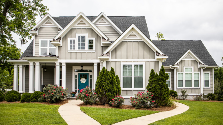 Home with trim and landscaping