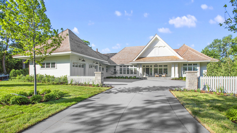 A home with a plain concrete driveway.