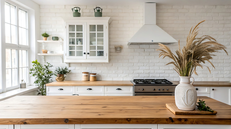 Kitchen with white exposed brick backsplash
