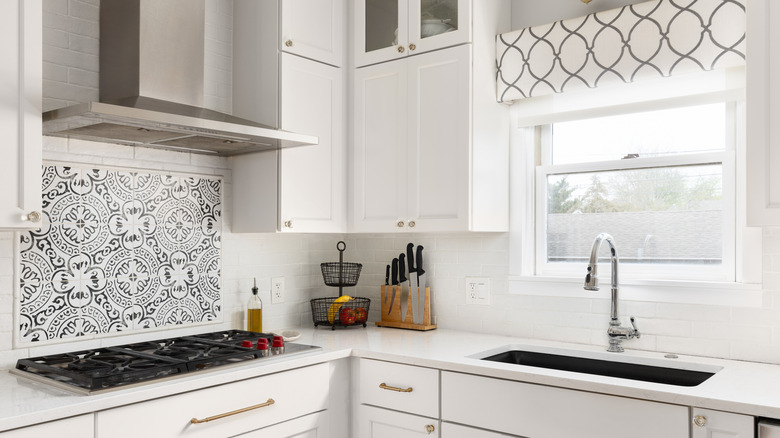 Kitchen with two different backsplashes: white tile and patterned tile