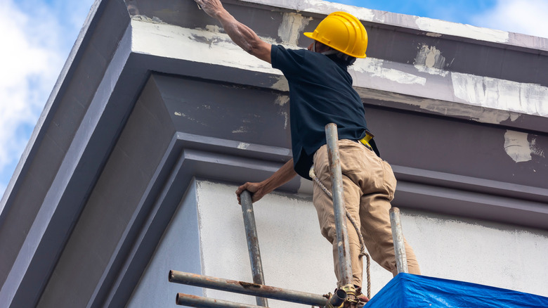prepping a fascia on a house for painting