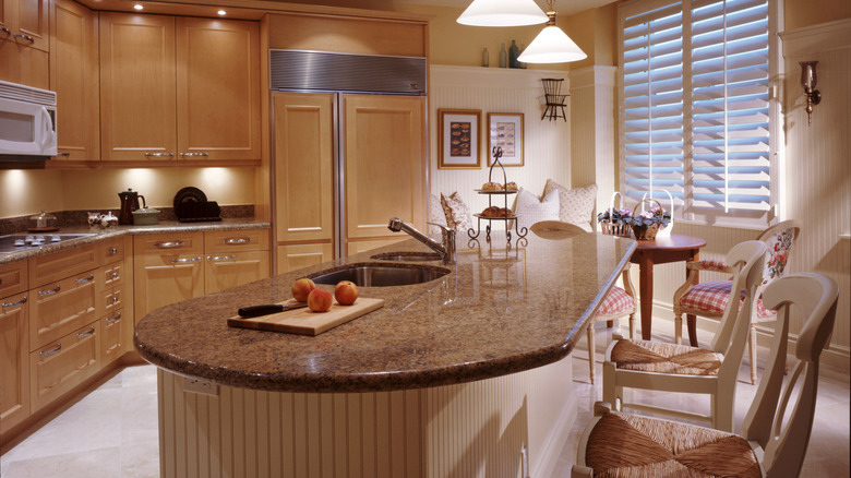 A cozy kitchen scene, including a rounded kitchen island