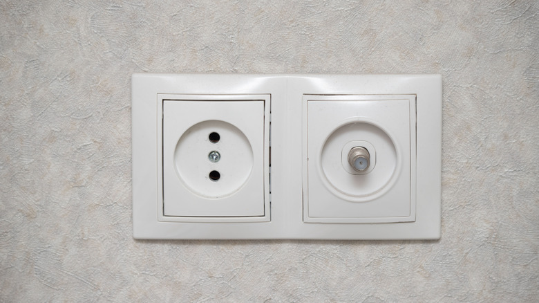 A white two-pronged outlet in a home