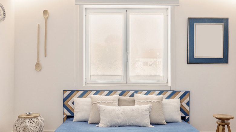 A bed beneath a window