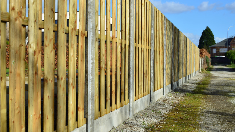Properly repaired concrete fence base standing upright