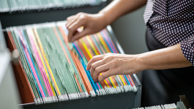 woman looking through filing cabinet