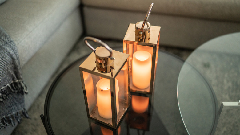 Candle lanterns on a glass table