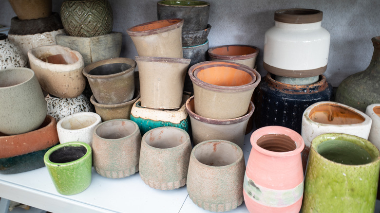 a collection of empty planters in different colors and sizes
