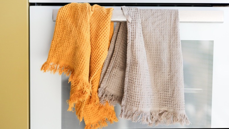 towels hanging on oven door